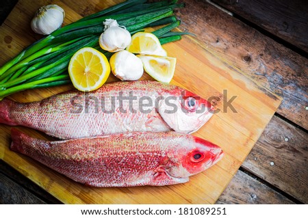Fresh red snapper preparation with lemon and vegetables