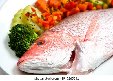 Fresh Red Snapper Or Red Snapper Ready To Be Cooked With Steamed Vegetables, Close Up View