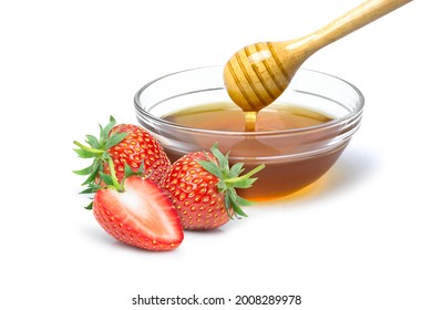Fresh red Strawberry and honey in glass bowl isolated on white background.
