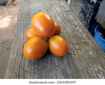 Fresh Red Tomatoes Arranged on Rustic Wooden Surface with Natural Light and Detailed Texture - Powered by Shutterstock