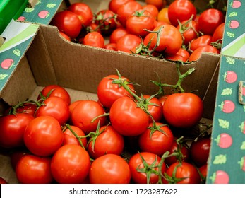 Fresh Red Tomatoes In A Cardboard Box On The Counter Supermarket