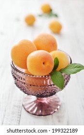 Fresh Ripe Apricots In Glass Ramekin On Wooden Background