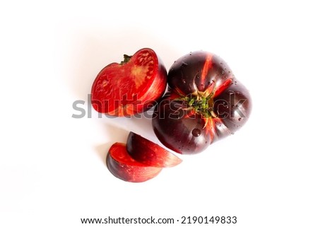 Fresh ripe black tomato isolated on a white background. Krim or Kumato tomatoes.