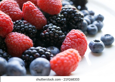 Fresh Ripe Blackberries, Raspberries And Blueberries On White Background