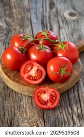 fresh ripe bunch tomatoes on wood background