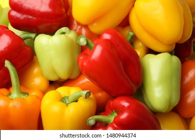 Fresh ripe colorful bell peppers as background, top view