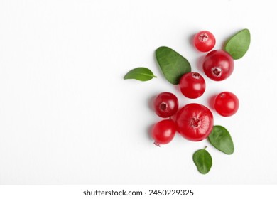 Fresh ripe cranberries and green leaves on white background, flat lay. Space for text - Powered by Shutterstock