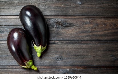Fresh ripe eggplant. On black wooden background
