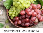 Fresh ripe grapes on wooden table, top view