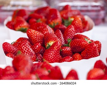 Fresh ripe juicy strawberry in boxes on a market counter