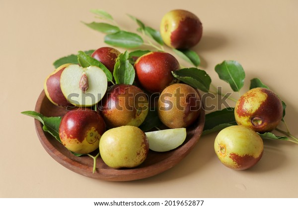 Fresh ripe\
Jujube Fruits with clipping path.Fresh jujubes with green leaves\
isolated.Sliced of fresh\
jujubes.