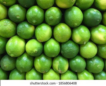 Fresh, Ripe Limes Stacked In Rows At A Local Farmers Market. 