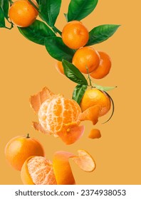 Fresh ripe mandarine with leaves falling in the air. Cut and whole mandarine isolated on yellow background. tangerines on branch Food levitation concept. High resolution image
