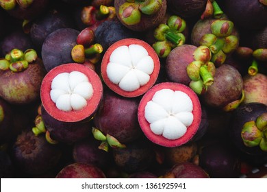 Fresh ripe mangosteen fruits and cross section showing the thick purple skin and white flesh. - Image