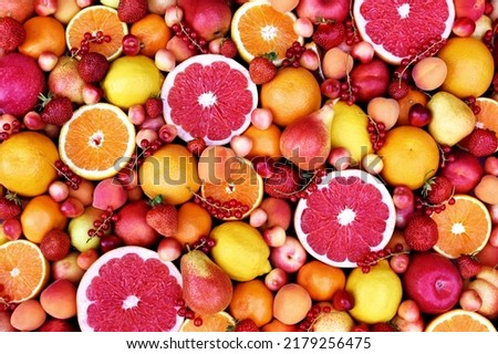 Fresh ripe organic fruits from market: pear and orange, grapefruit and lemon, apricot and berries