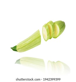 Fresh ripe organic vegetable marrow cut into several slices isolated on white floats freely in the air. Concept of fresh vegetables, diet, food levitation.