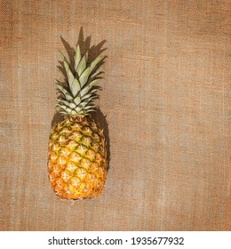 Fresh, Ripe Pineapple On A Natural Textile Background With Copy Space. Local Market, Farm Fruits. Top View, Topical Fruit Background For Harvest Day Celebration. The Concept Of Mindful Consumption