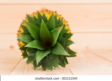 Fresh Ripe Pineapple In Top View On The Wooden Background.