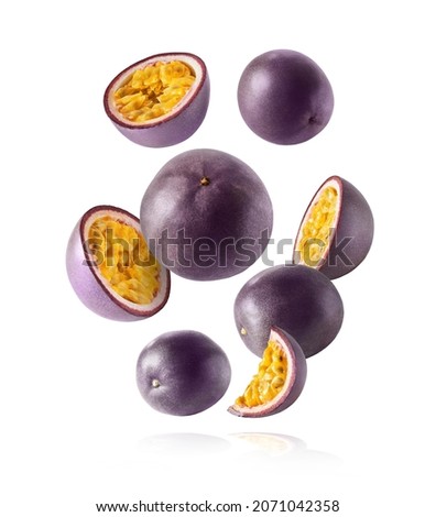 Fresh ripe raw passion fruit falling in the air isolated on white background. Zero gravity and food levitation concept. High resolution