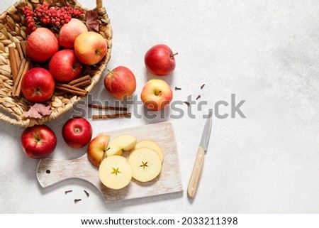 Fresh ripe red apples with knife and chopping board on white table background. Autumn apple flat lay, top view, copy space. Autumn harvest and cooking apple meal, apple pie concept