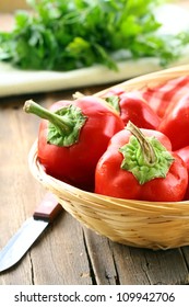 Fresh Ripe Red Bell Paprika Peppers  In A Wicker Basket