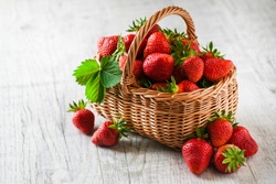Fresh Ripe Strawberries In Wicker Basket On White Rustic Table. 