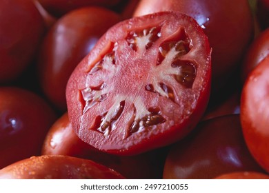 Fresh ripe tomatoes with one sliced in half - Powered by Shutterstock