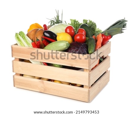 Fresh ripe vegetables and fruit in wooden crate on white background