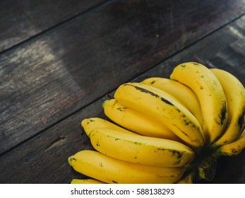 Fresh ripe yellow bananas, on wooden background