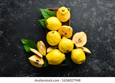 Fresh ripe yellow quince. Fruits in a wooden box. Top view. Free space for text. - Powered by Shutterstock