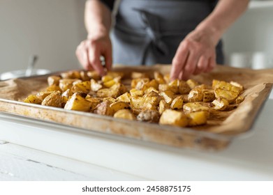 Fresh roasted and chopped potatoes on a baking sheet - Powered by Shutterstock