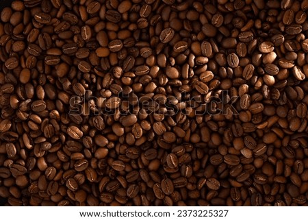 Fresh roasted coffee beans texture with lightbeam
