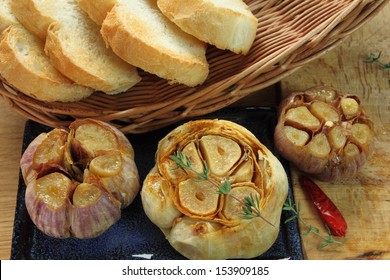 Fresh Roasted Garlic With Olive Oil And Bread.