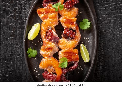 Fresh roasted skewer as a Mediterranean dinner. Shashlik with grilled shrimps and salmon.