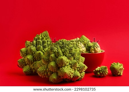 Fresh Romanesco broccoli on red background