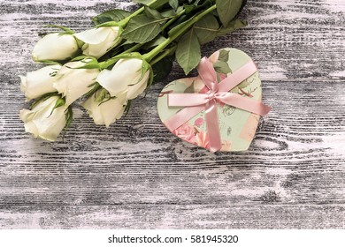 Fresh roses flowers with heart on gray painted wooden background. Place for text. Post card, greeting card mock up.