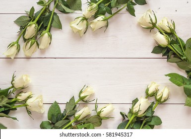 Fresh roses flowers on white painted wooden background. Place for text. Post card, greeting card mock up.