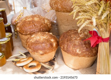 Fresh Round Bread With A Golden Crust Close-up On A Wooden Board. The Concept Of Food Stability.