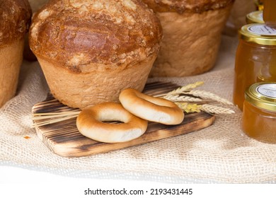 Fresh Round Bread With A Golden Crust Close-up On A Wooden Board. The Concept Of Food Stability.