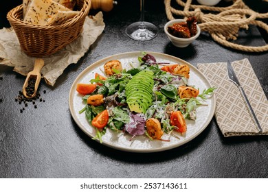 Fresh salad with avocado, grilled shrimp, baby greens, and cherry tomatoes served with red wine - Powered by Shutterstock