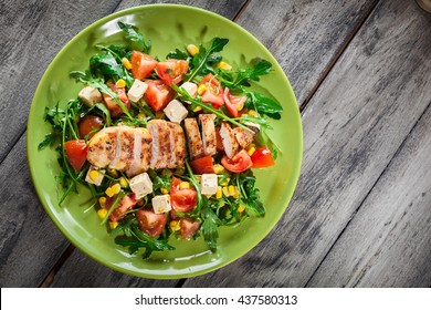 Fresh Salad With Chicken Breast, Arugula And Tomato On A Plate