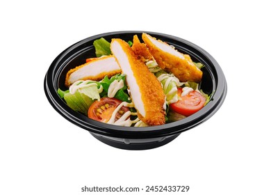 Fresh salad with crispy chicken strips in a black takeout bowl isolated on white