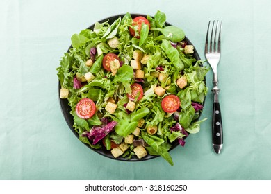 Fresh salad with croutons, tomatoes and olives - Powered by Shutterstock