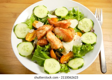 Fresh Salad With Grilled Cubes Of Teriyaki Salmon, Cheese Chunks On Bed Of Spring Mix Lettuce With Cucumber And Tomatoes