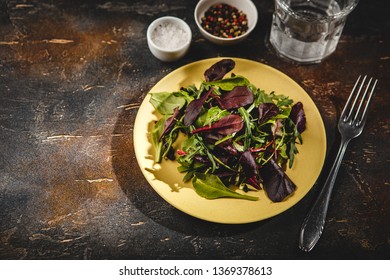 Fresh salad mix of baby spinach, arugula leaves and chard in green plate, healthy food - Shutterstock ID 1369378613