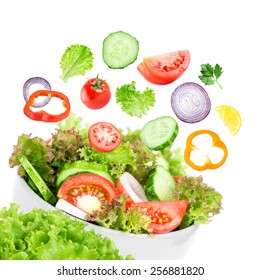 Fresh Salad. Mixed Falling Vegetables In Bowl On White Background