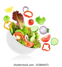 Fresh Salad. Mixed Falling Vegetables In Bowl On White Background