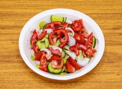 Fresh Salad With Tomato, Cucumber, Onion And Green Chili Served In Plate Isolated On Table Top View Of Indian And Pakistani Spicy Food