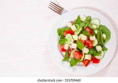 Fresh Salad With Tomatoes, Arugula, Cucumber And Cheese Cubes