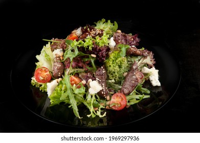 Fresh Salat With Meat, Tomatoes, Salat On The Black Plate.